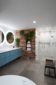 bathroom remodel ideas round mirrors blue vanity wood wall plant wall marble shower gold faucets