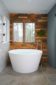 Bathroom Design and Remodel in Atlanta with contemporary vanity, marble tile, walk in shower, gold shower, gold faucets, wood wall, white tile, round mirrors.